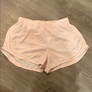 All light pink Nike running shorts
